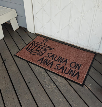 Ruskea saunan matto - "Sauna on aina sauna"